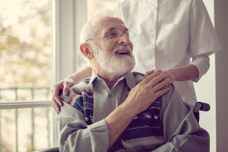 Resident holding hands with a nurse.