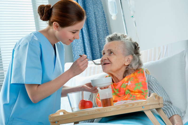 Nurse feeding a resident.