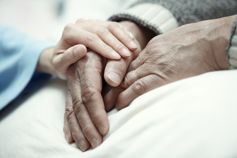 Nurse holding hands with a resident.