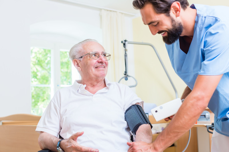 A nurse taking a patients blood pressure.