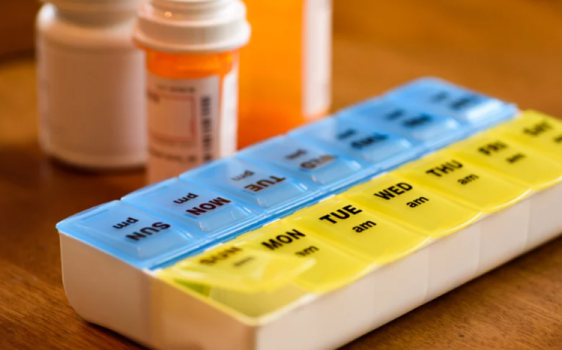 A close up image of a weekly pill organizer.