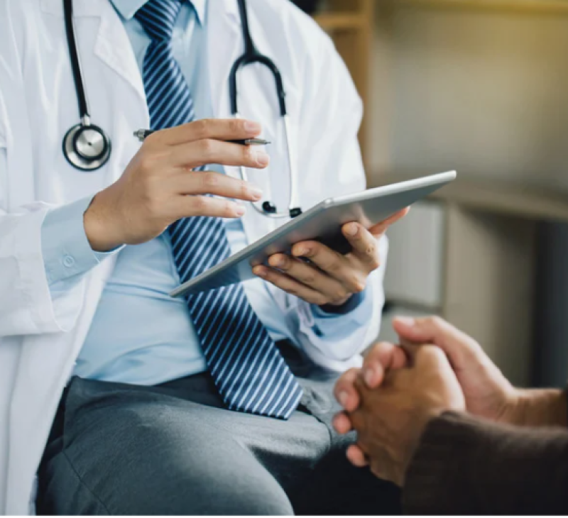 Doctor writing information from a patient down during a therapy session.