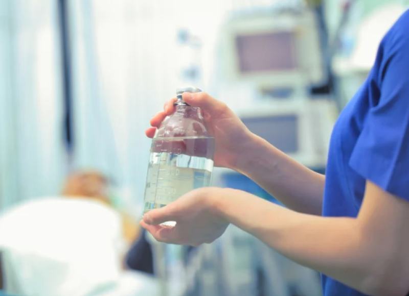 Nurse administering TPN to a patient.